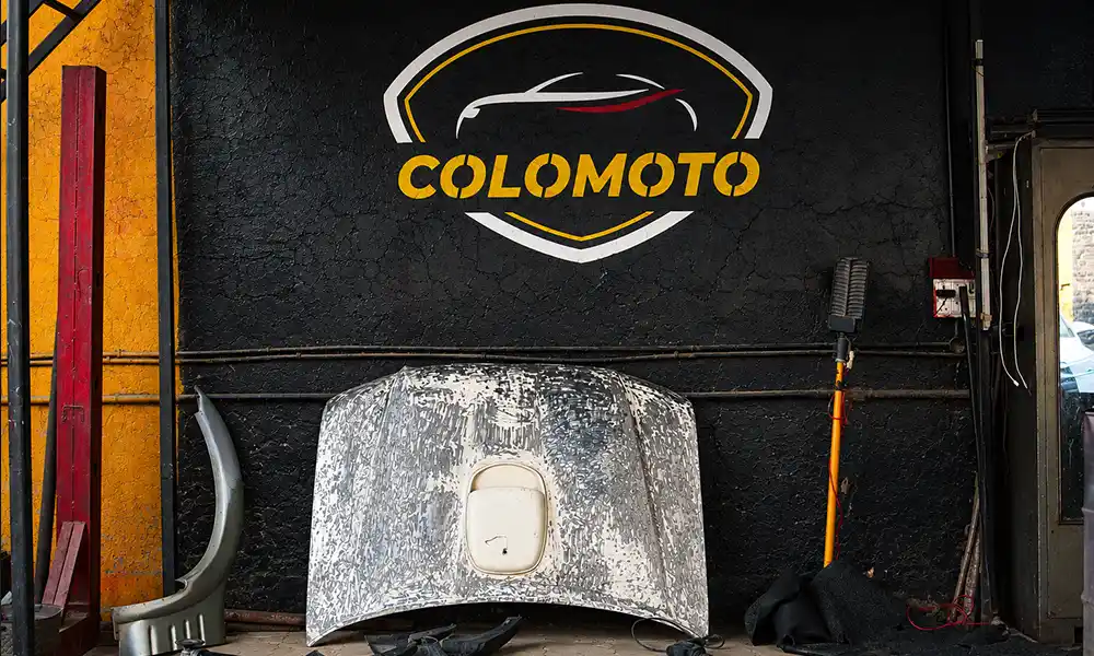 Car fully disassembled before full body painting at Colomoto